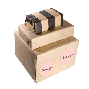 Pink round thank you seal stickers on cardboard boxes for gift packaging and mailing