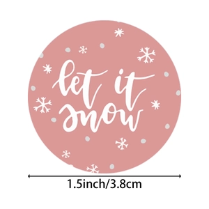 Pink Christmas sticker with 'Let It Snow' text and snowflake design in 1.5 inch round size