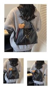 Detail of black large capacity soft leather backpack with cute bear charm and pocket zipper