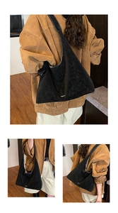 Macro shot of black hobo bag with contrast stitching and knot tie detail for daily use