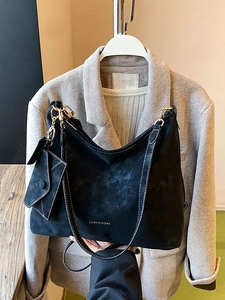 Modern black suede tote bag with contrast stitching and matching small pouch