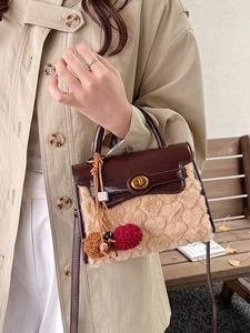 Brown and tan heart-embossed faux fur handbag with leather handle and plush charm