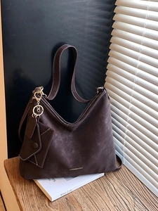 Retro coffee brown suede tote bag with small envelope pouch accessory on wooden table