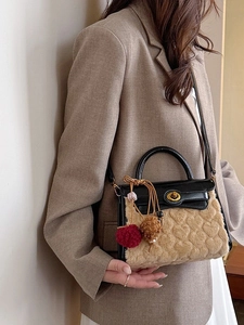 Chic two-tone heart textured handbag with plush finish and elegant golden twist lock