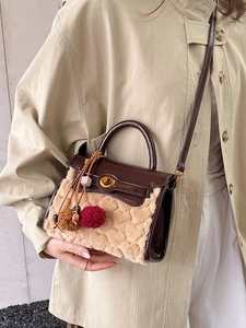 Brown leather crossbody bag with heart-texture faux fur and plush charm on model