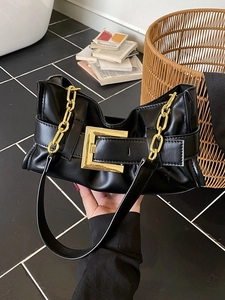 Chic black pleated handbag with a large gold buckle and chunky chain strap details