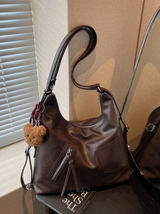 Large dark brown leather hobo shoulder bag with zipper details and cute bear charm