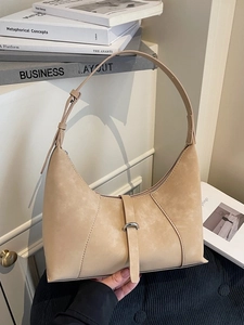 Minimalist beige half-moon underarm bag with metal ring buckle and adjustable strap