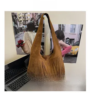 Detail of brown suede hobo bag featuring stylish multi-layered long fringes