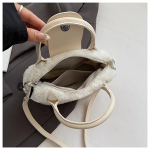 Macro view of white faux fur bag showing magnetic buckle and grey fabric lining