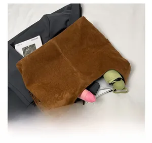 Detail view of large brown suede tote bag interior showing spacious capacity with items