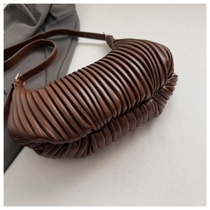 Detail view of the deep chocolate brown ruched pleats on this vintage crescent handbag