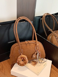 Brown matte oversized tote bag with plush donut charm and dual shoulder straps