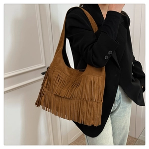 Detail of the layered brown fringe and suede texture on this boho-style tote bag