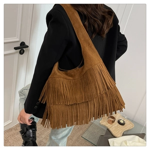 Detail of bohemian brown tassel tote bag showing suede texture and layered fringes