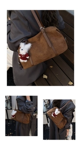 Detail of vintage brown suede tote bag with plush bunny charm and adjustable strap