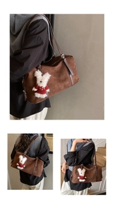 Close-up of retro brown suede tote bag with dark leather strap and plush bunny charm