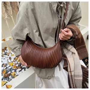 Detailed view of the vertical pleats on this vintage dark brown croissant bag