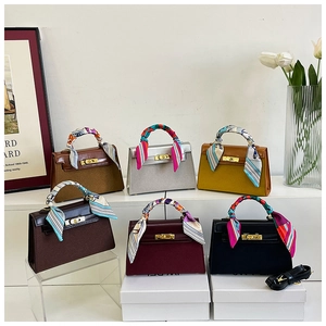 Detail shot of vintage matte Kelly-style bags in six colors with silk scarf handles