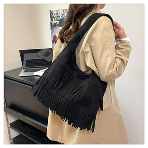 Detail of black suede fringe tote bag with multi-layer tassels for bohemian style