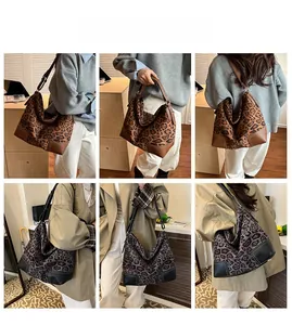 Detail view of large leopard print tote bags in brown and dark grey with leather corner pads