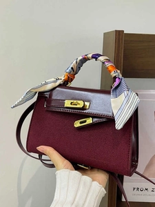 Vintage burgundy handbag with silk scarf handle and golden twist-lock closure