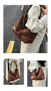 Leopard print tote bag with brown leather bottom and white stitching details