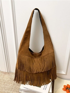 Bohemian brown suede hobo bag with long tassels and wide shoulder strap in caramel finish