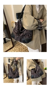 Detail of hobo tote bag with leopard print fabric and black leather corner reinforcement