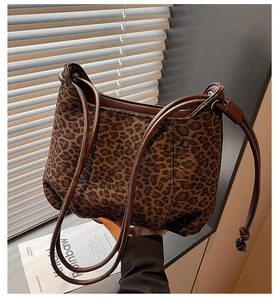 Detailed view of vintage leopard print tote bag with thin brown leather shoulder straps