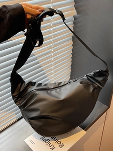 Sac bandoulière demi-lune noir minimaliste avec sangle réglable en décor de style de vie
