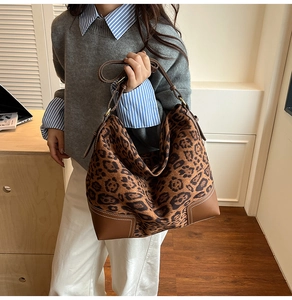 Detail of the leopard print tote with leather corner accents and precise white stitching