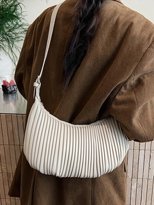 Chic beige pleated crescent bag with vertical stripes and slim shoulder strap