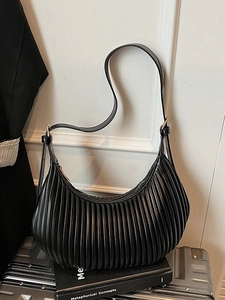 Chic black pleated hobo bag with vertical stripes and sleek shoulder strap design