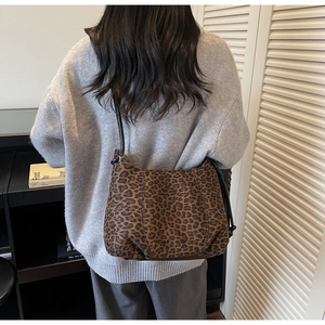 Leopard print hobo tote bag showing large capacity and soft drape on model shoulder