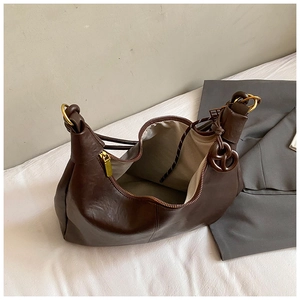 Detail view of large dark brown hobo bag showing zipper closure and spacious interior