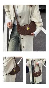 Detailed close-up of dark brown woven hobo bag with a yellow triangular metal buckle