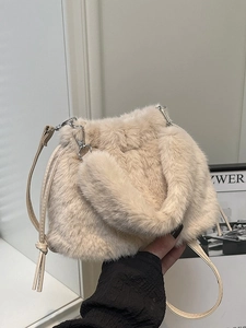 Light beige plush bucket bag with soft faux fur texture and silver metal hardware