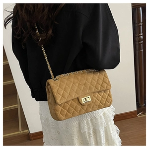 Detail of camel suede shoulder bag with diamond stitching and gold chain strap