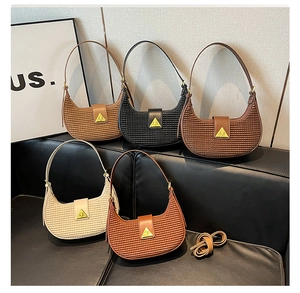 Detail of woven crescent underarm bags in five colors with triangle gold metal locks