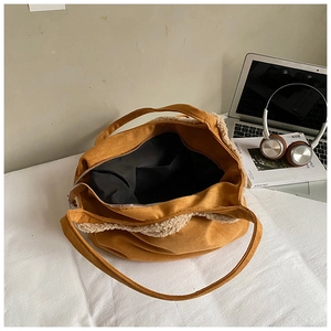Detail showing ginger corduroy tote bag with fleece trim and black interior pocket