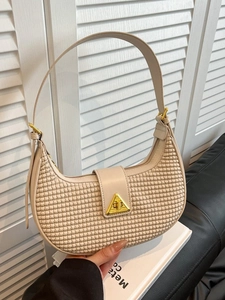 Beige crescent hobo bag with textured woven surface and golden triangular buckle