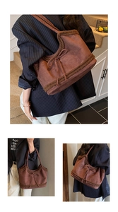 Detail of dark brown suede tote bag featuring plush faux fur trim and bow tie decoration