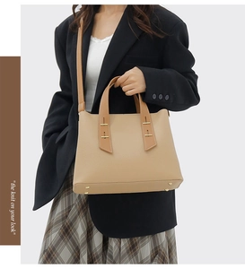 Litchi texture khaki tote bag with adjustable shoulder straps on a stylish model