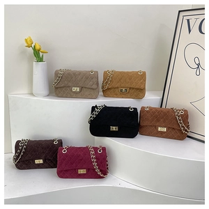 Detail view of quilted velvet crossbody bags in six vintage colors with chain straps