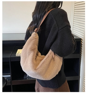 Detailed back view of a plush light brown crescent shoulder bag with adjustable strap