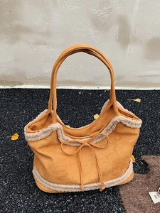 Large lamb wool suede tote bag in ginger orange with fleece trim and bow detail