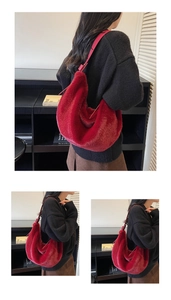 Detailed view of a large red plush hobo bag with matching leather shoulder straps