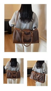 Detail of waterproof nylon travel bag with leather straps and detachable shoulder strap