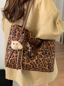 Retro leopard print tote bag with brown handles and bear charm in a shoulder-carry style